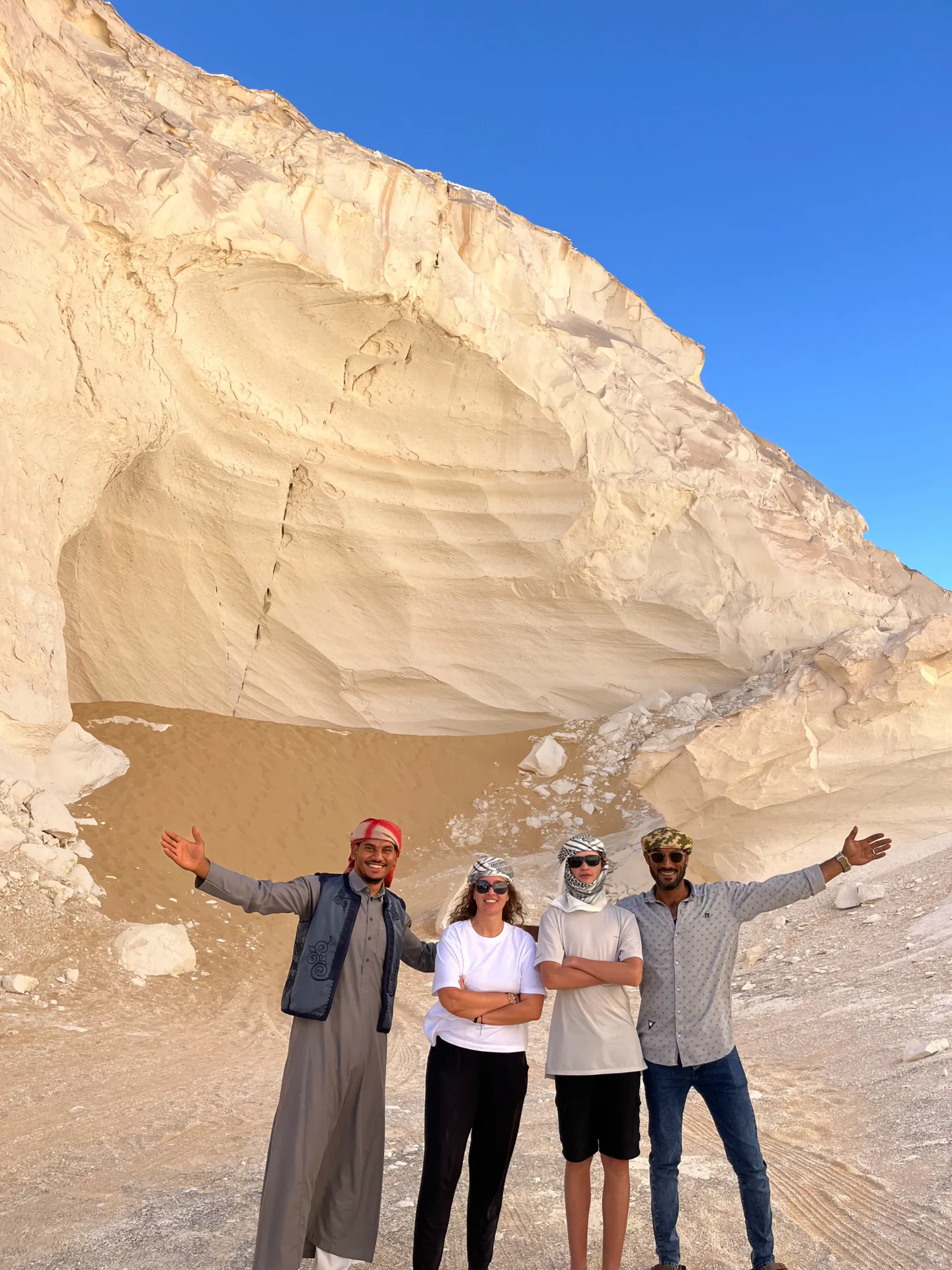Local guide with international guests in Egypt's White Desert during a solar eclipse tour