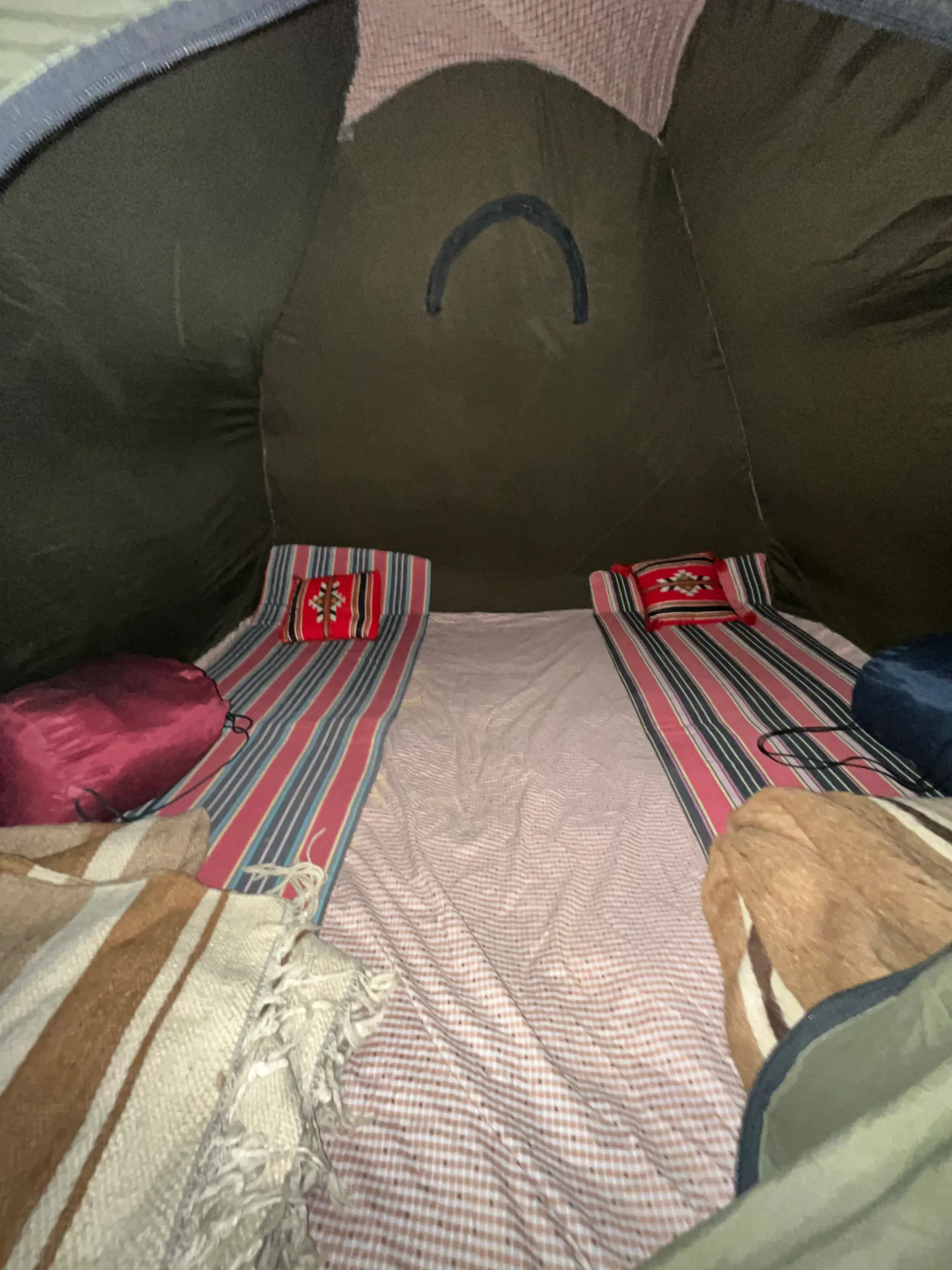 Beds arranged inside a private desert sleeping tent from a camp operated by our team